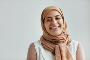 A woman in a headscarf smiling