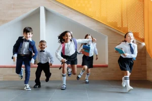 School children running towards their classroom