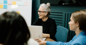 Three women sat at a roundtable discussion or workshop