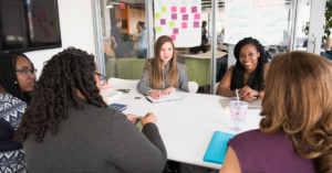 A group of people around a table at a workshop