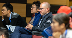 An audience at a conference or lecture listening