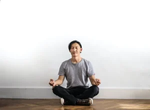 Find your zen - A man sat legs crossed meditating